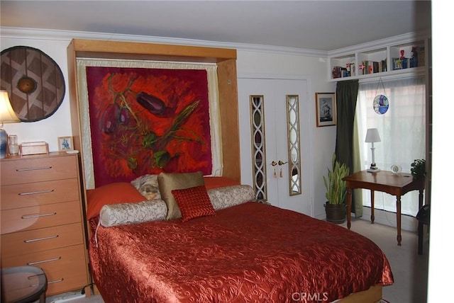 carpeted bedroom featuring french doors and ornamental molding