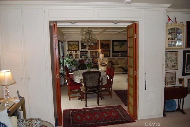 dining area featuring crown molding and light colored carpet