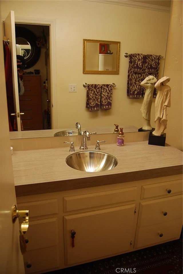 bathroom featuring vanity and crown molding