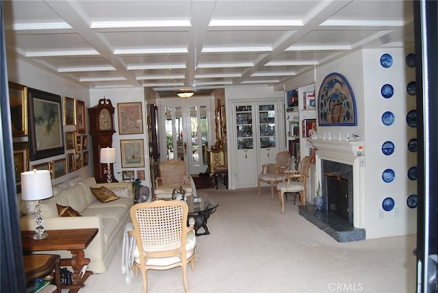 carpeted living room featuring beamed ceiling, a premium fireplace, and coffered ceiling