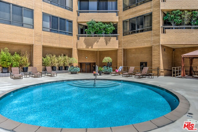 view of pool featuring a gazebo and a patio area