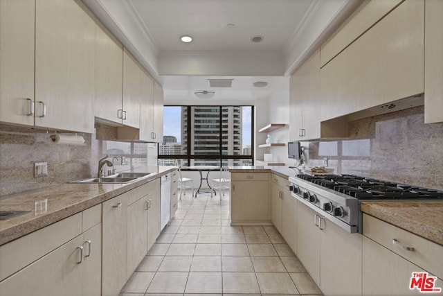 kitchen with sink, crown molding, light tile patterned floors, decorative backsplash, and stainless steel gas stovetop