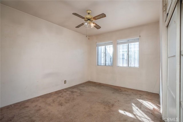 unfurnished bedroom with ceiling fan, carpet flooring, and a closet