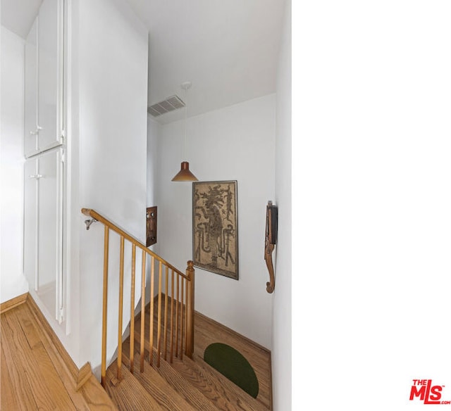 stairs with wood-type flooring