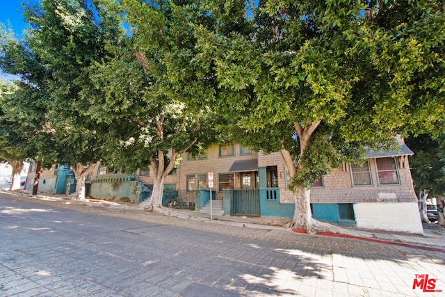 view of property hidden behind natural elements