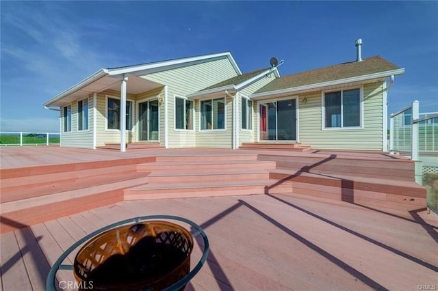 back of property featuring a wooden deck