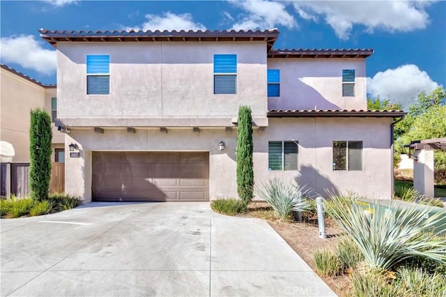 mediterranean / spanish home featuring a garage