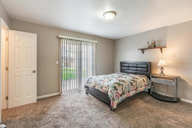 carpeted bedroom with a textured ceiling and access to outside