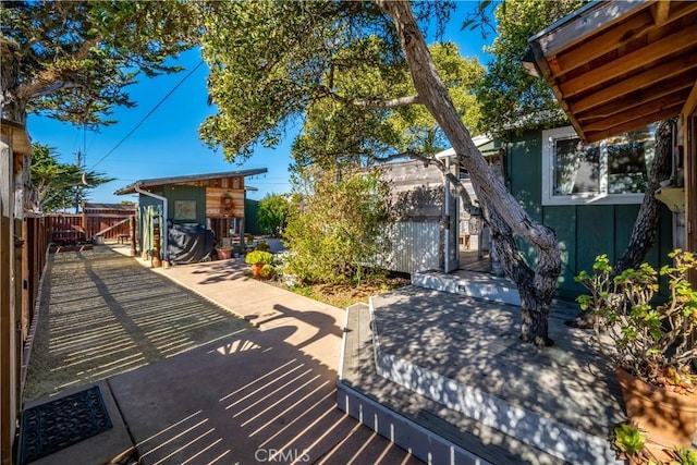 view of patio / terrace with a storage unit and a deck