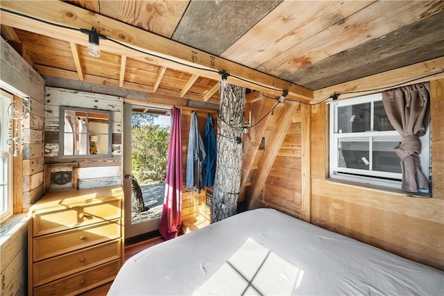 unfurnished bedroom featuring beam ceiling, wooden walls, and wood ceiling