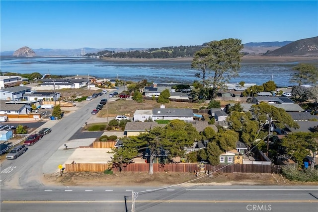 birds eye view of property with a water and mountain view