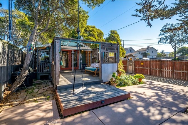 view of patio / terrace featuring an outbuilding and a deck