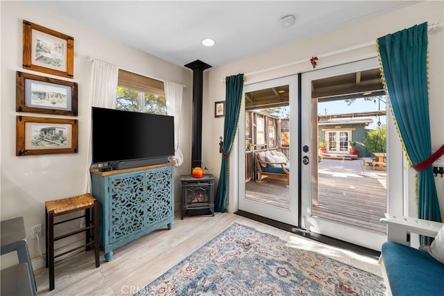 doorway featuring light wood-type flooring and a wood stove