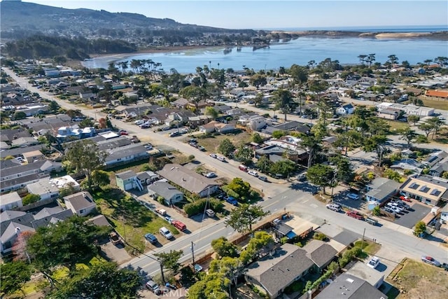 birds eye view of property with a water and mountain view