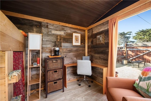 home office with wood-type flooring, lofted ceiling, wood ceiling, and wooden walls