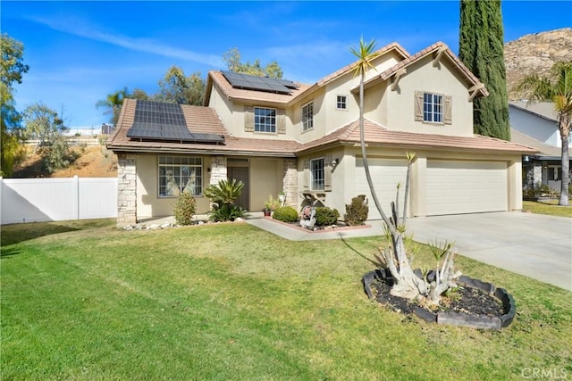 view of front of home featuring a garage, a front lawn, and solar panels