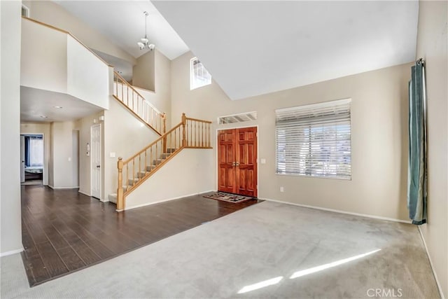 carpeted entryway with a high ceiling