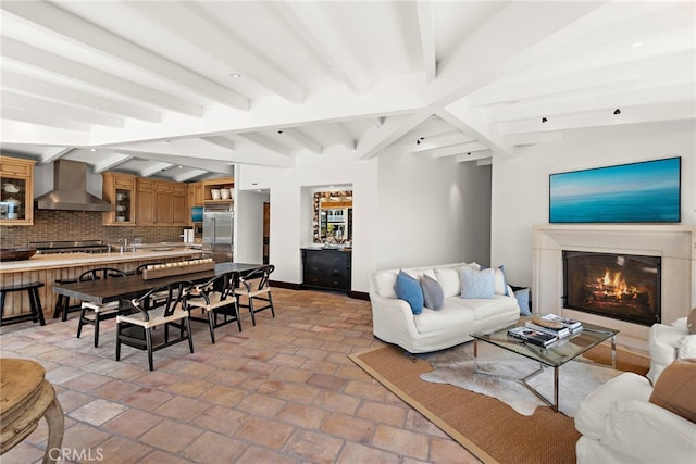 living room featuring lofted ceiling with beams