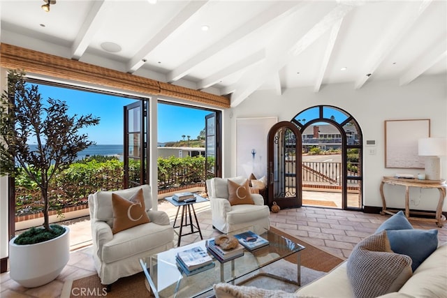 living room with a water view and beam ceiling