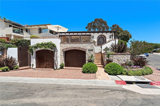 view of front of home featuring a garage and a balcony