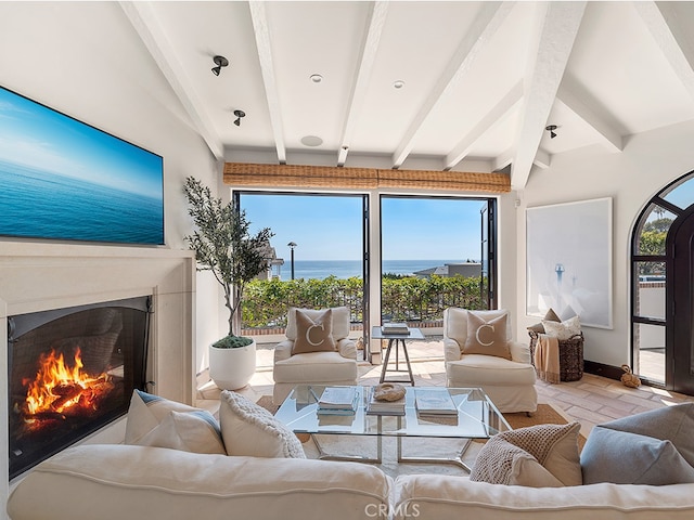 living room featuring a water view and beam ceiling