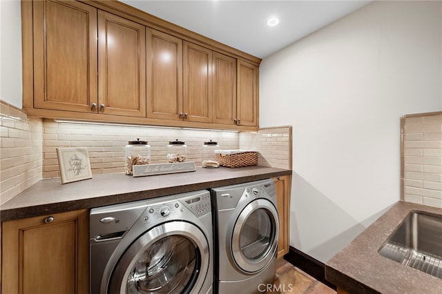 laundry room with separate washer and dryer, sink, tile patterned floors, and cabinets