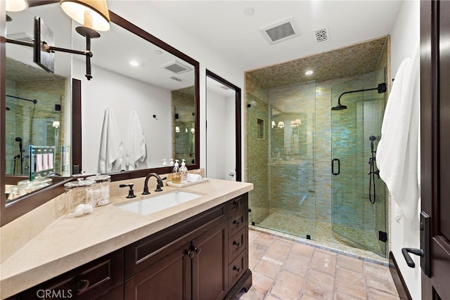 bathroom featuring vanity and a shower with door