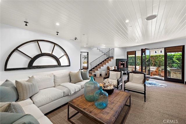 carpeted living room with wooden ceiling