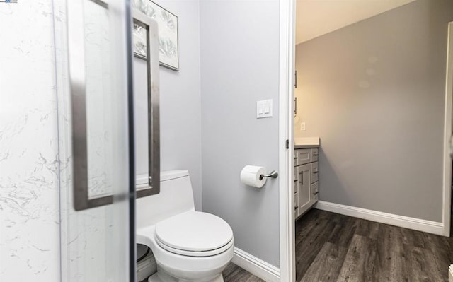 bathroom featuring hardwood / wood-style flooring, vanity, and toilet