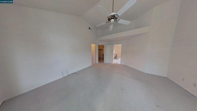 spare room with ceiling fan, high vaulted ceiling, and light carpet