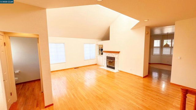 unfurnished living room featuring hardwood / wood-style flooring and a high end fireplace