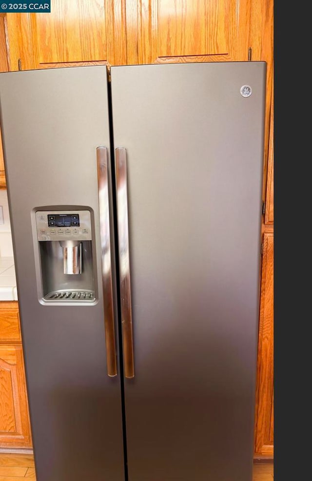 details featuring stainless steel refrigerator with ice dispenser