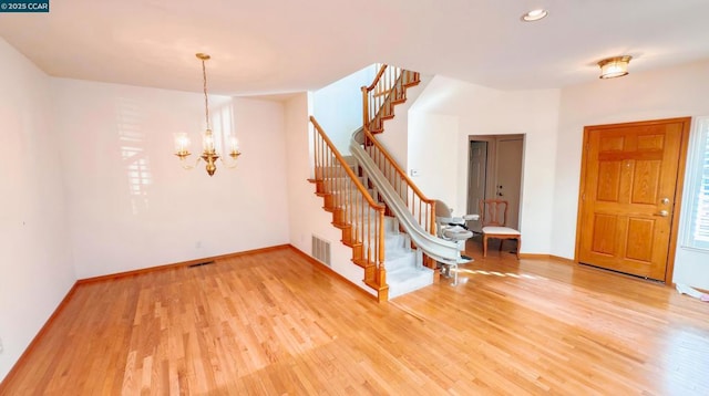 interior space featuring an inviting chandelier and hardwood / wood-style flooring