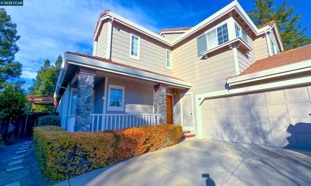 view of front facade with a garage and a porch