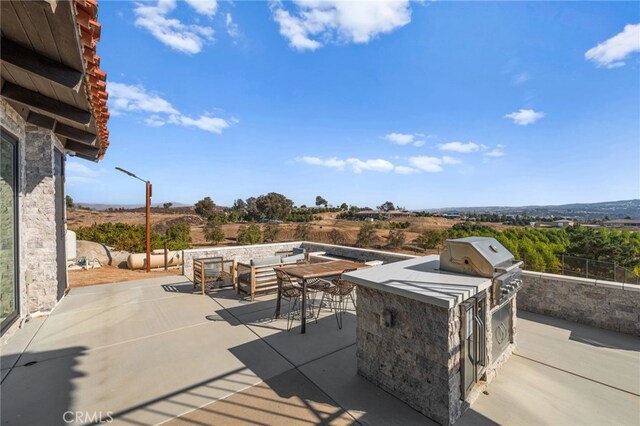 view of patio featuring an outdoor kitchen and area for grilling