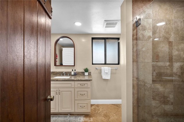 bathroom featuring vanity and a tile shower