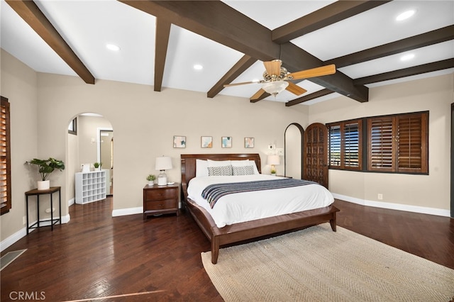 bedroom featuring beam ceiling, dark wood-type flooring, and ceiling fan