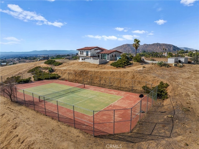 view of tennis court with a mountain view