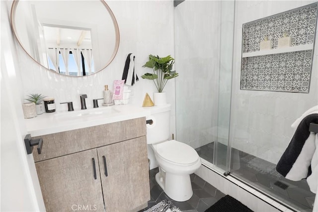 bathroom featuring vanity, tile patterned floors, a shower with door, and toilet