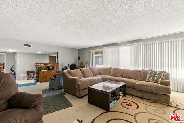 living room with light colored carpet and a textured ceiling