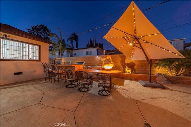 view of patio / terrace with an outdoor fire pit and an outdoor bar