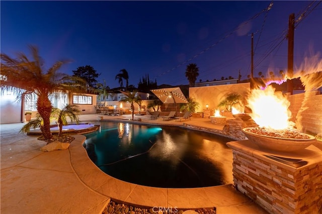 view of pool with an outdoor fire pit and a patio