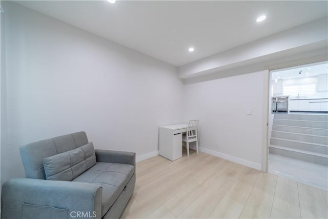 sitting room featuring sink and light hardwood / wood-style flooring