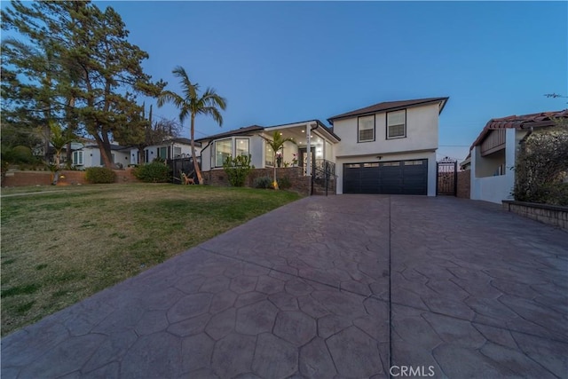 view of front of property featuring a garage and a front yard