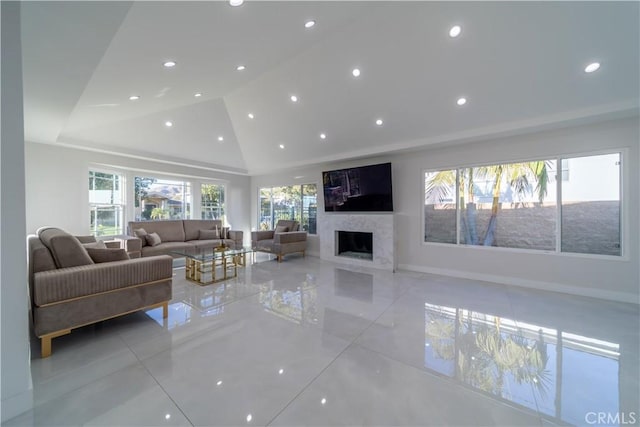 living room with a premium fireplace and high vaulted ceiling