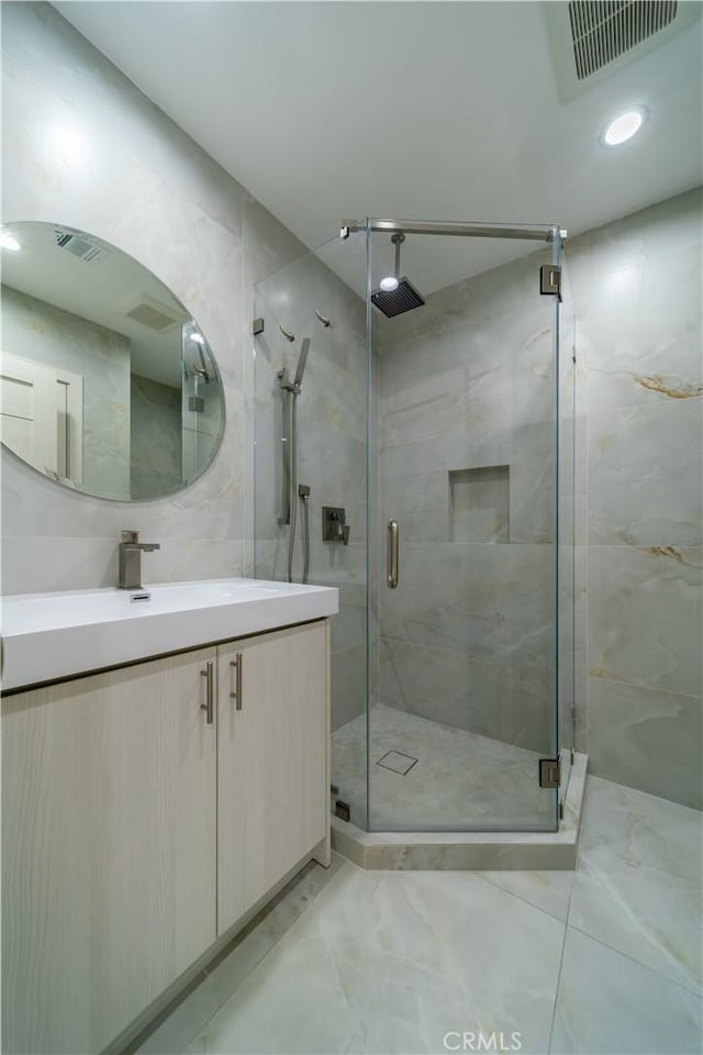 bathroom featuring vanity and an enclosed shower