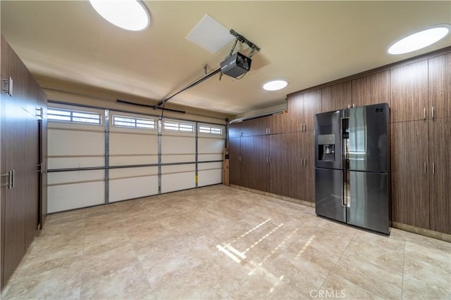 garage with a garage door opener and refrigerator with ice dispenser