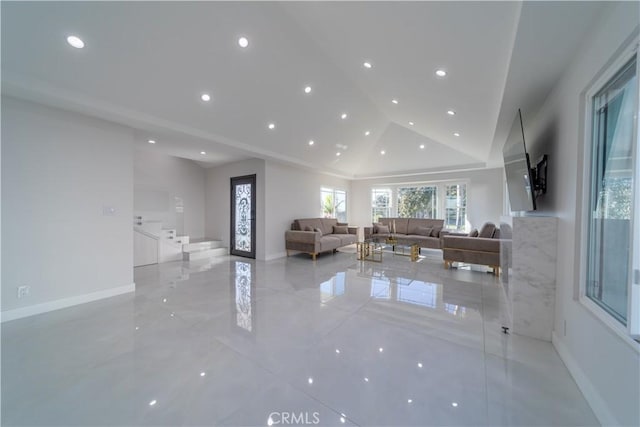 unfurnished living room featuring high vaulted ceiling