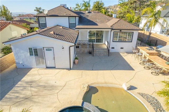 back of property featuring a bar and a patio area