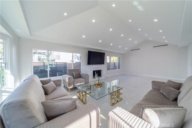 living room with vaulted ceiling and a high end fireplace